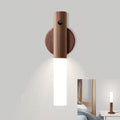 Wooden wall sconce with a white light fixture on a gray wall.